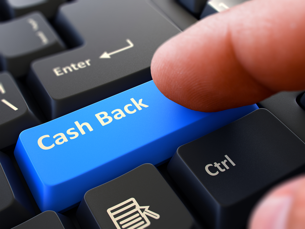 One Finger Presses blue Button Cash Back on Black Computer Keyboard. Closeup View. Selective Focus.