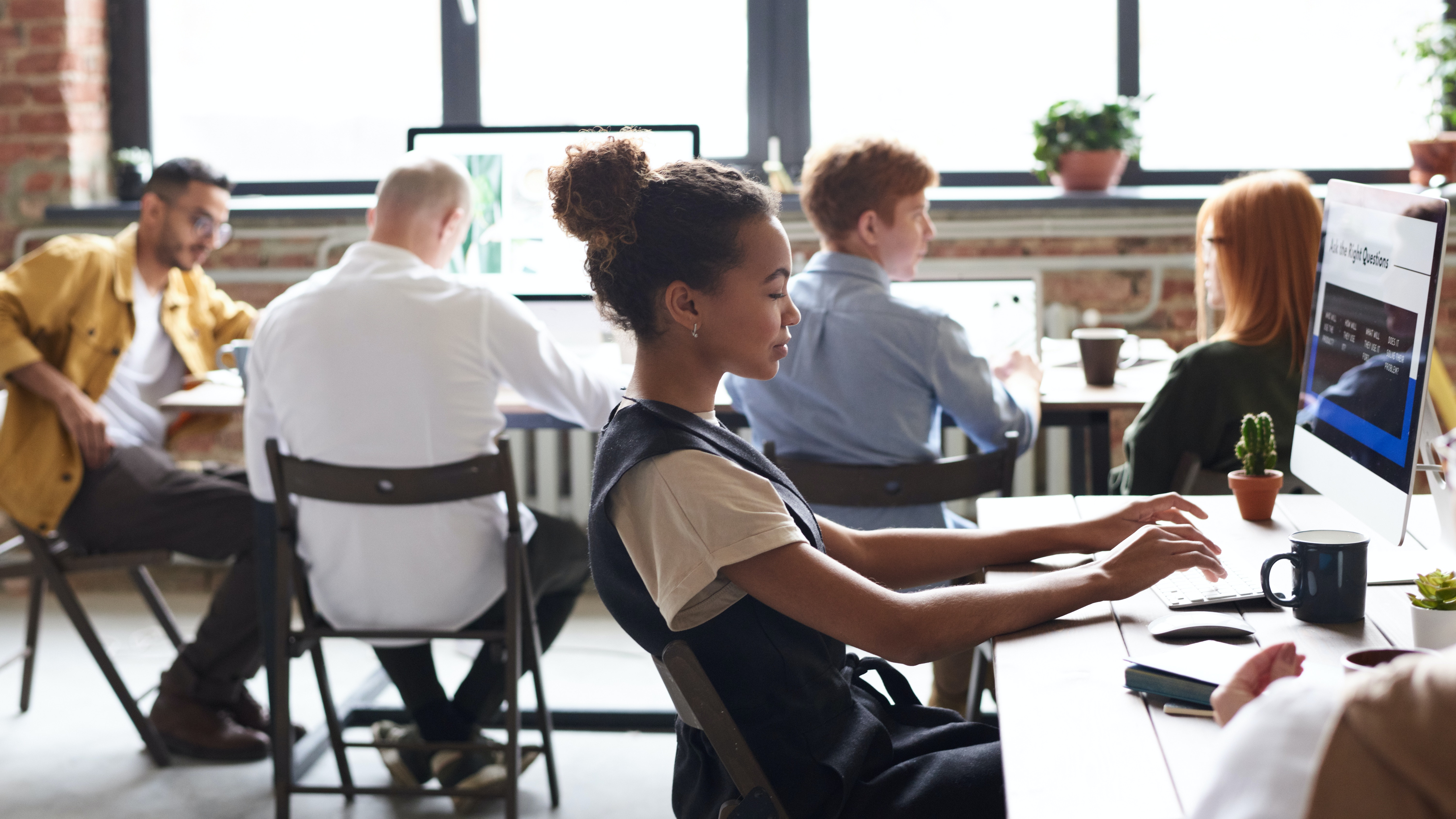 girl working with a group behind her